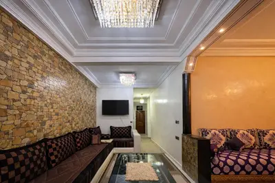 a living room with a couch and a brick wall at Residence Bouanane B in Fès