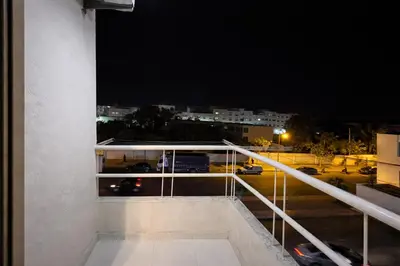 a balcony with a view of a street at night at Residence Bouanane B in Fès