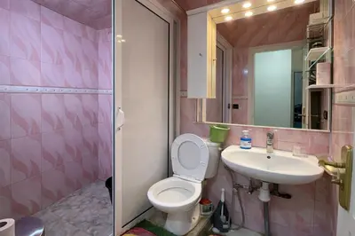 a pink bathroom with a toilet and a sink at Residence Bouanane B in Fès