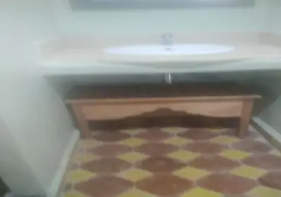 a bathroom with a sink and a tiled floor at Riad Tin Hinane in Merzouga