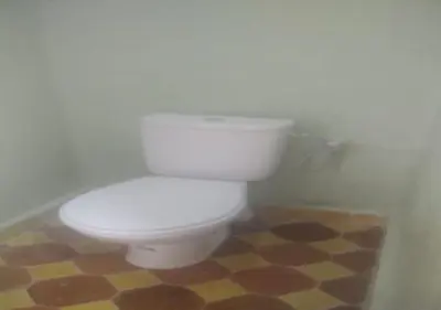 a bathroom with a white toilet in a room at Riad Tin Hinane in Merzouga