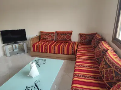 a living room with a couch and a tv at STOPOVER 1 MIDELT in Midelt