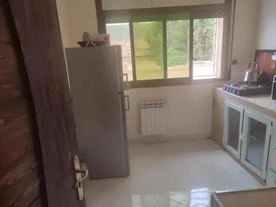a kitchen with a white refrigerator and a window at STOPOVER 1 MIDELT in Midelt
