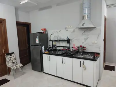 a kitchen with a stove and a refrigerator at ESCALE 1midelt in Midelt