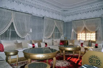 a living room with a couch and chairs and a window at Jolie villa moderne avec piscine privée. in Marrakech