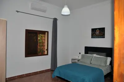 a bedroom with a bed and a window at Jolie villa moderne avec piscine privée. in Marrakech