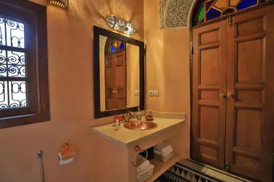 a bathroom with a sink and a mirror at Riad Moulaydriss et Giacomo in Fès