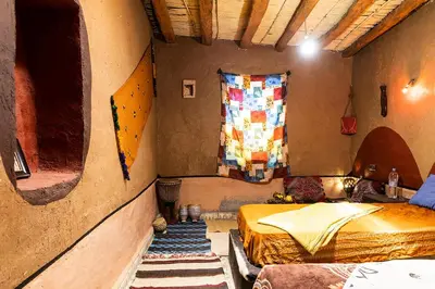 a room with two beds and a window in it at Dar Jamila in Achbarou