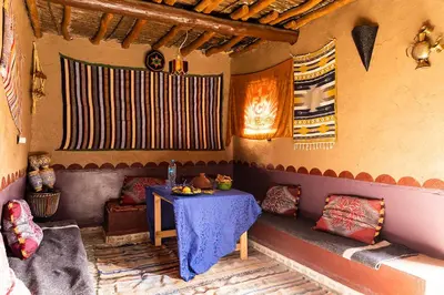 a room with a table and a table and chairs at Dar Jamila in Achbarou