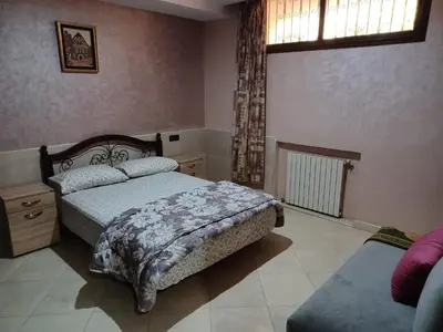 a bedroom with two beds and a window at The Orchard Comfy & Cozy Apartment 2 in Ifrane