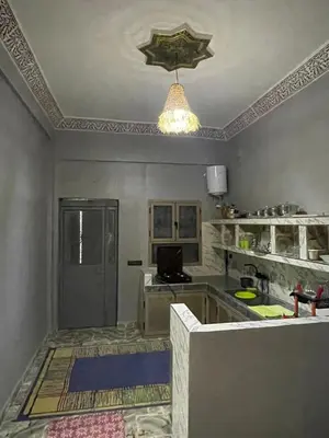 a kitchen with a table and a ceiling at Appartement moha merzouga in Merzouga