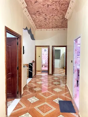a hallway with a tile floor and a ceiling at Appartement moha merzouga in Merzouga