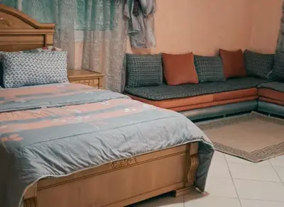 a living room with a bed and a couch at Stunning 3-Bed Villa in Fes near fes sais airport in Fès