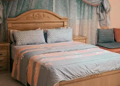 a bedroom with a large bed and a chair at Stunning 3-Bed Villa in Fes near fes sais airport in Fès