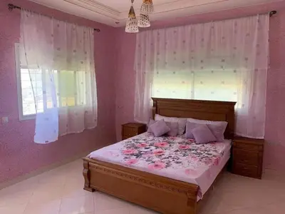a bedroom with a bed with pink walls and windows at Stunning 3-Bed Villa in Fes near fes sais airport in Fès