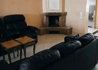 a living room with a couch and a fireplace at Stunning 3-Bed Villa in Fes near fes sais airport in Fès