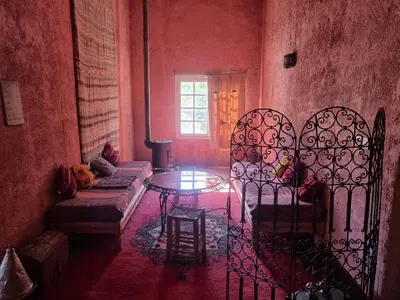 a living room with a iron gate and a table at Gîte Camping Amazigh in Azrou