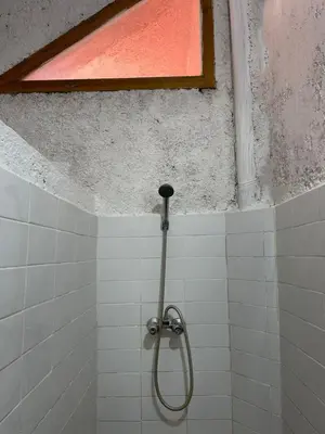 a shower in a tiled bathroom with a window at Gîte Camping Amazigh in Azrou