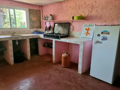 a kitchen with a sink and a refrigerator in a room at Gîte Camping Amazigh in Azrou