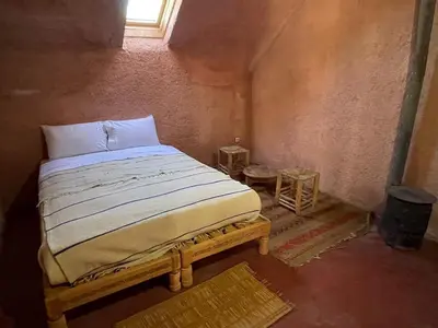 a bedroom with a large bed in a room at Gîte Camping Amazigh in Azrou
