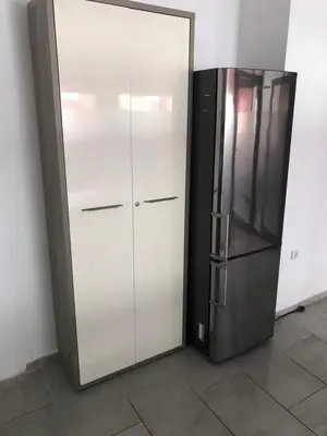 a kitchen with a refrigerator next to a wall at Chez ZAKARIA de Lyon in Meknès