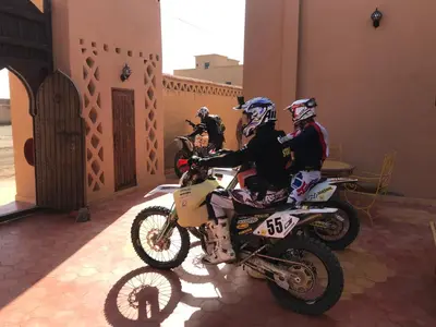 a group of people on motorcycles parked in a building at Riad Moha in Merzouga