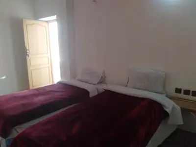 two beds sitting next to each other in a room at Hotel et Restaurant Riad Amodou in Tinerhir