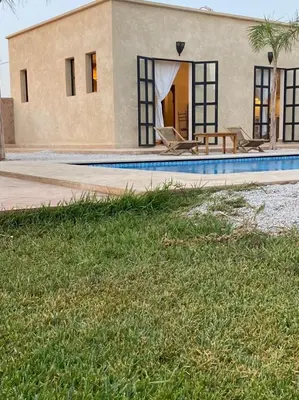 a house with a swimming pool in front of it at Dar Mamoun in Marrakech
