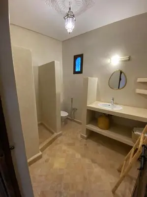 a bathroom with a sink and a toilet and a mirror at Dar Mamoun in Marrakech