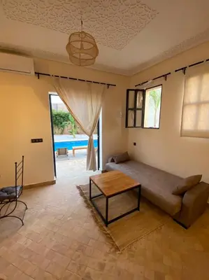 a living room with a couch and a table at Dar Mamoun in Marrakech
