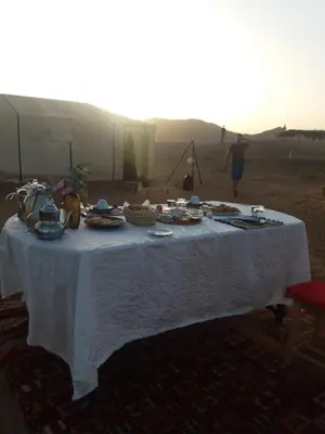 a table with food on it in the desert at Zagora Luxury Camp in Zagora