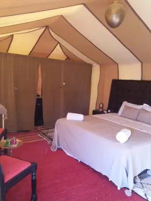 a bedroom with a large bed in a room at Zagora Luxury Camp in Zagora