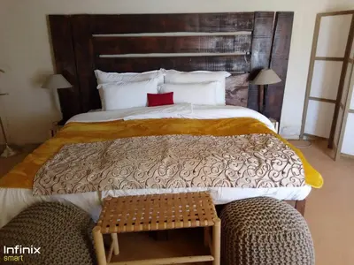a bedroom with a large bed with a red laptop on it at Zagora Luxury Camp in Zagora