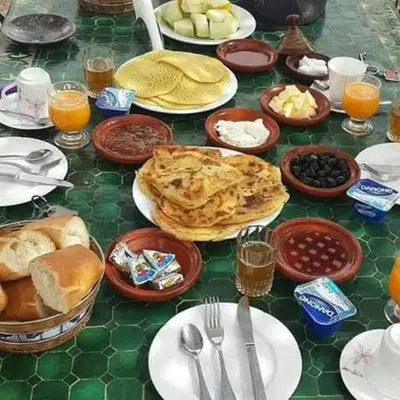 a table topped with plates of food on top at Zagora Luxury Camp in Zagora