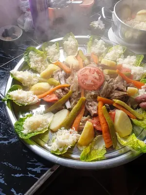 a plate of food with vegetables on a table at auberge restau tombouctou in Aït Ben Haddou