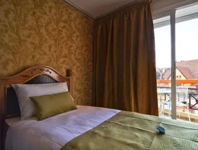 a bedroom with a bed and a large window at Résidence Ifrane Palace in Ifrane