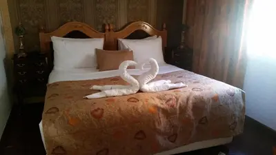 two swans towels sitting on top of a bed at Résidence Ifrane Palace in Ifrane