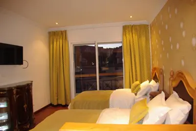 a hotel room with two beds and a window at Résidence Ifrane Palace in Ifrane