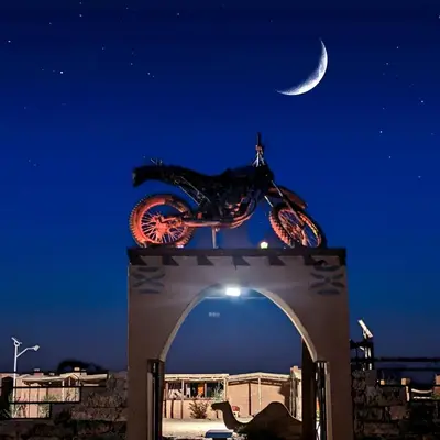 a bike on top of an arch at night at Café restaurante shelter calm life in Bou Dib