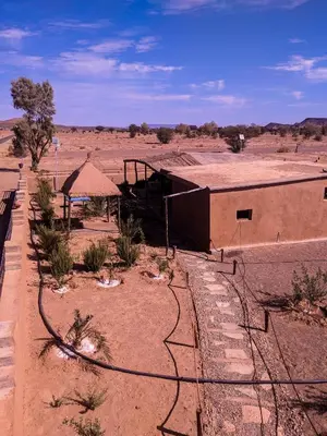 a building in the middle of the desert at Café restaurante shelter calm life in Bou Dib