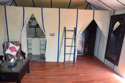 a room with a tent with a ladder in it at Relaxing Desert Camp in Merzouga