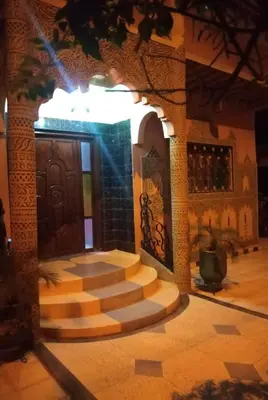 a building with a set of stairs in front of a door at Villa Eden in Ouarzazate
