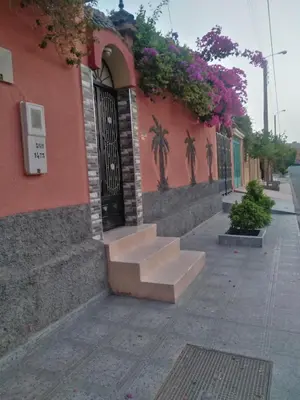 a building with stairs in front of a building with flowers at Villa Eden in Ouarzazate