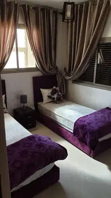 a bedroom with two beds and a window at Maison GHITA in Azrou
