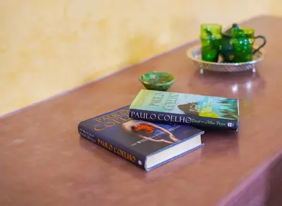 two books sitting on top of a table at Kasbah Hnini in Igdourane