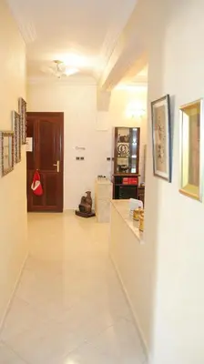 a room with a hallway with a counter and a door at Darkoum votre appartement in Fès