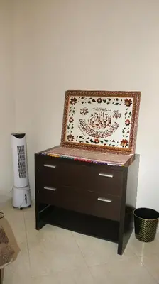 a dresser with a picture on top of it at Darkoum votre appartement in Fès