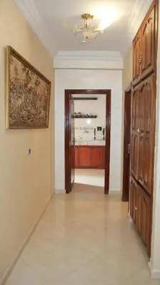 a room with a hallway with a painting on the wall at Darkoum votre appartement in Fès