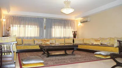 a living room with a couch and a coffee table at Darkoum votre appartement in Fès