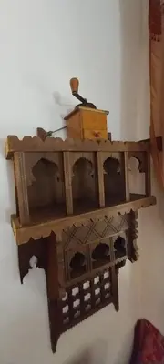 a wooden shelf hanging on a wall at Riad lala zakia in Moulay Idriss Zerhoun